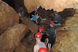 Climbing rocks in ATM cave