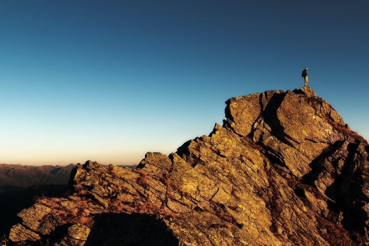 hiker on top of high elevation mountain